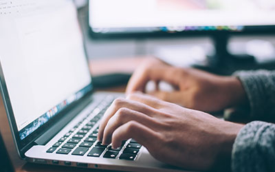 Person typing on a laptop
