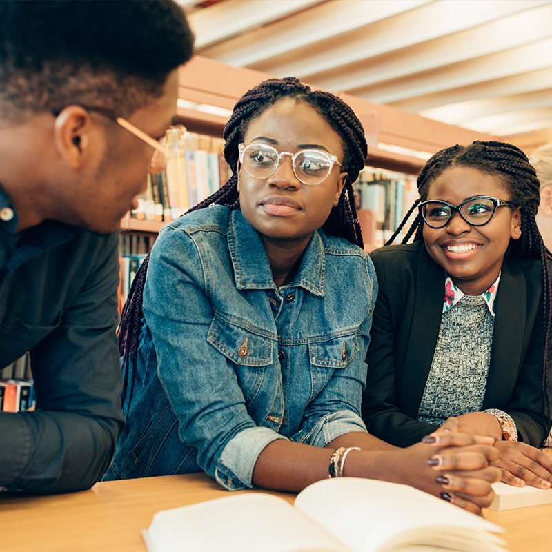 Three black students engaged in conversation
